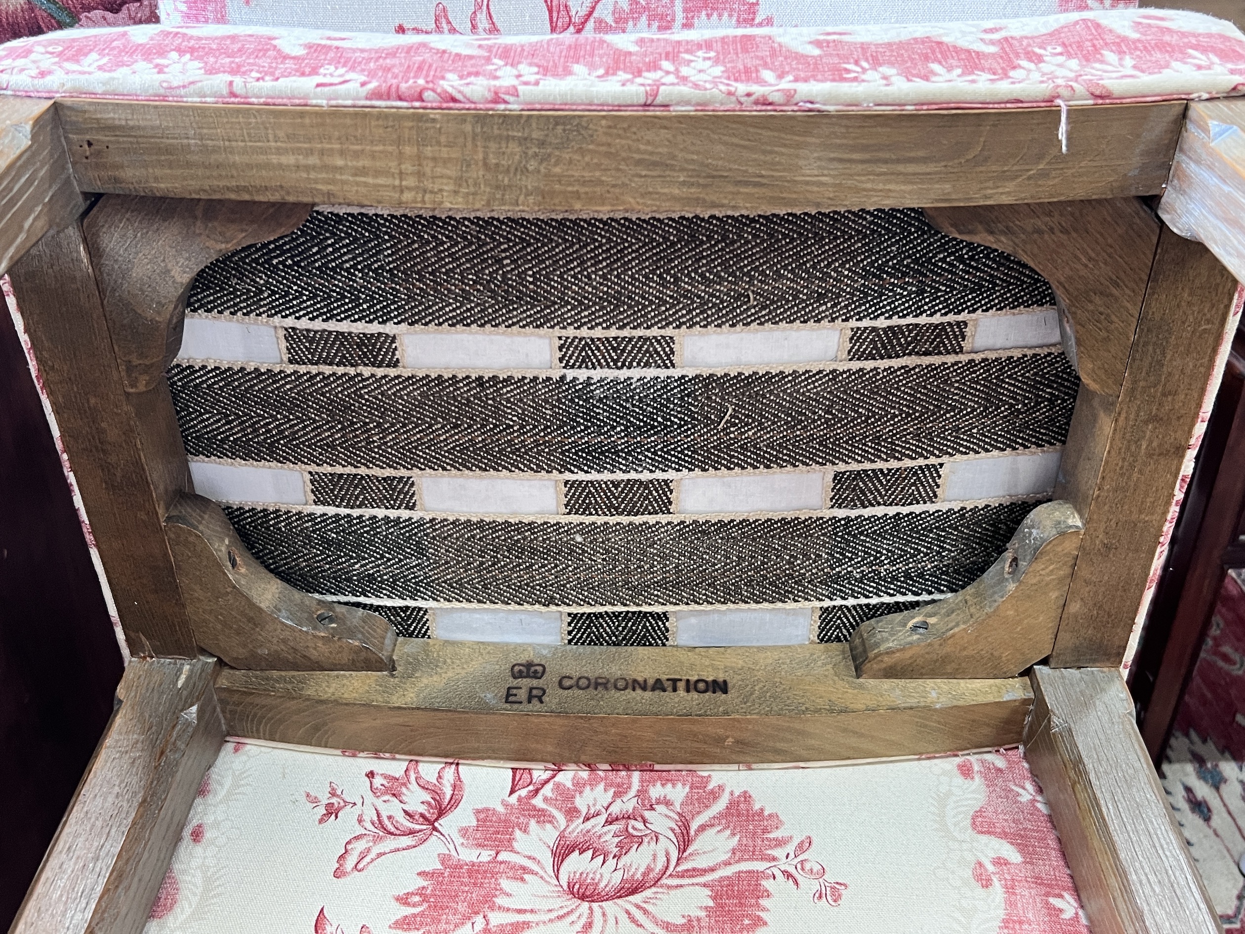 A reupholstered Coronation chair , the back applied with a George VI fabric remnant and an Elizabeth II Coronation stool